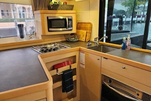 Never Say Never Yacht Photos Pics Modern kitchen in 2017 Lagoon 42 yacht with stove, microwave, and sink.