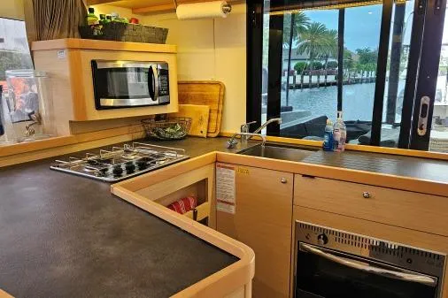 Never Say Never Yacht Photos Pics Modern kitchen interior of 2017 Lagoon 42 catamaran with appliances and waterfront view.