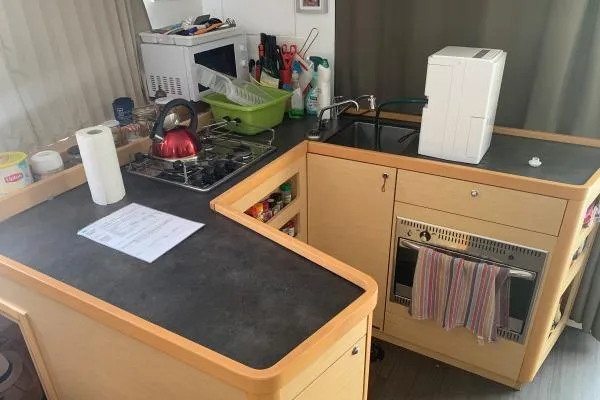 Never Say Never Yacht Photos Pics Compact kitchen in a 2017 Lagoon 42 catamaran with stove, sink, and appliances.