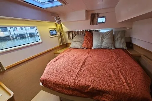 Never Say Never Yacht Photos Pics Cozy cabin interior of 2017 Lagoon 42 catamaran with a comfortable bed and scenic window view.