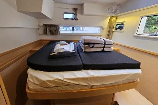 Never Say Never Yacht Photos Pics Cozy cabin interior of 2017 Lagoon 42 catamaran with neatly arranged bedding.