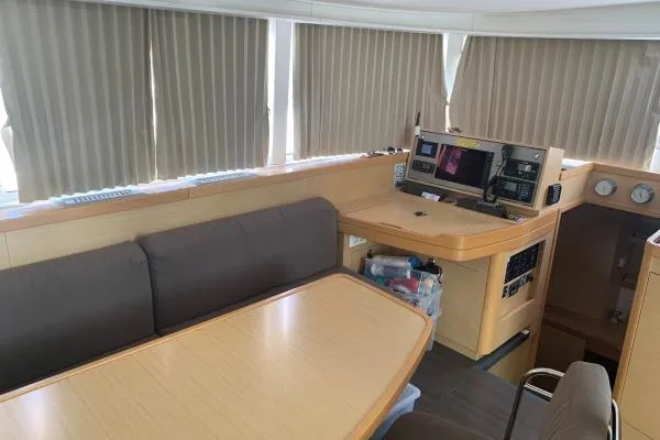 Never Say Never Yacht Photos Pics Interior of 2017 Lagoon 42 yacht with navigation station and seating area.
