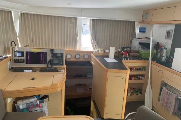 Never Say Never Yacht Photos Pics Interior of a 2017 Lagoon 42 catamaran with navigation station and kitchen area.
