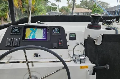 Never Say Never Yacht Photos Pics Cockpit of 2017 Lagoon 42 catamaran with navigation equipment and steering wheel.