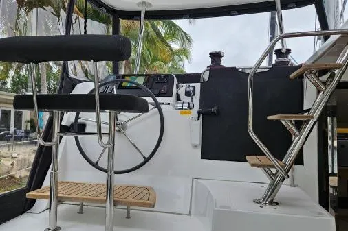 Never Say Never Yacht Photos Pics Cockpit of 2017 Lagoon 42 catamaran with steering wheel and seating.