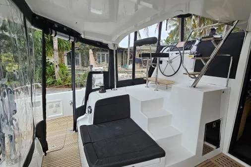 Never Say Never Yacht Photos Pics Interior view of a 2017 Lagoon 42 catamaran, featuring helm and seating area.