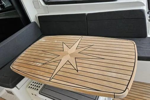 Never Say Never Yacht Photos Pics Teak table with star design on 2017 Lagoon 42 yacht interior.