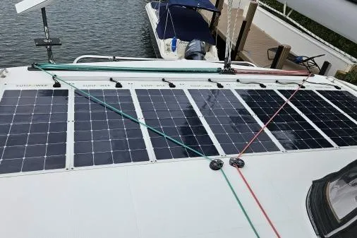 Never Say Never Yacht Photos Pics 2017 Lagoon 42 catamaran with solar panels on deck, docked at marina.