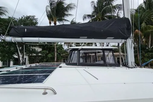 Never Say Never Yacht Photos Pics 2017 Lagoon 42 catamaran with solar panels, docked near palm trees.