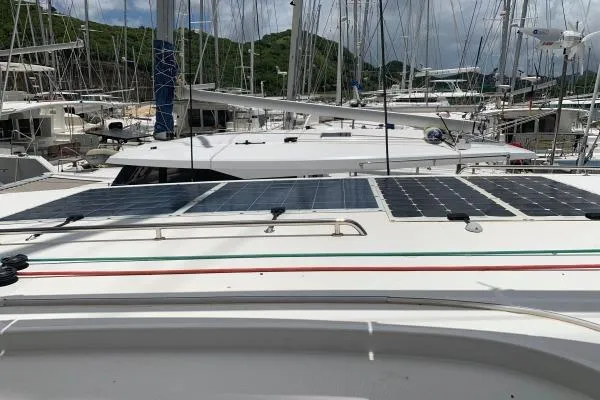 Never Say Never Yacht Photos Pics 2017 Lagoon 42 catamaran with solar panels docked in a marina.