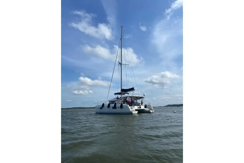 Never Say Never Yacht Photos Pics 2017 Lagoon 42 catamaran sailing on calm waters under a clear blue sky.