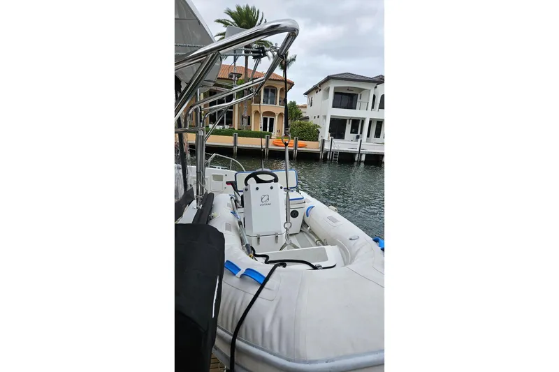 Never Say Never Yacht Photos Pics 2017 Lagoon 42 yacht with Zodiac tender docked near waterfront homes.