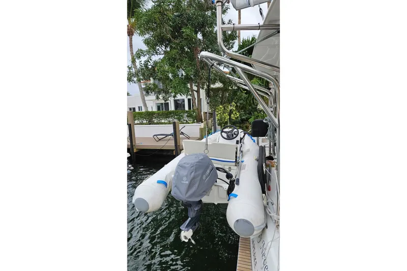 Never Say Never Yacht Photos Pics 2017 Lagoon 42 yacht with attached inflatable dinghy and outboard motor.
