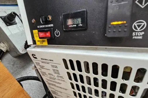 Never Say Never Yacht Photos Pics Control panel of a 2017 Lagoon 42 boat, featuring circuit breakers and hour meter.