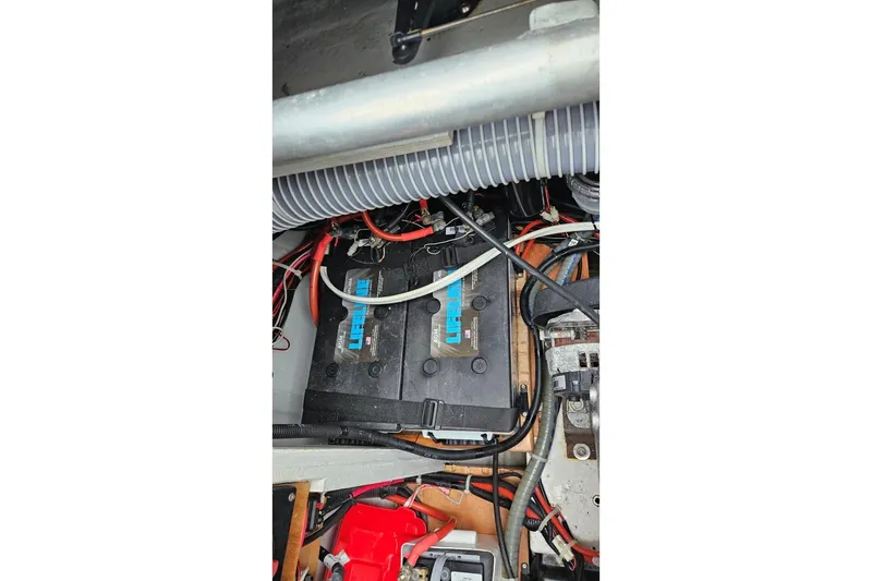 Never Say Never Yacht Photos Pics Engine compartment of a 2017 Lagoon 42 catamaran with visible wiring and battery.