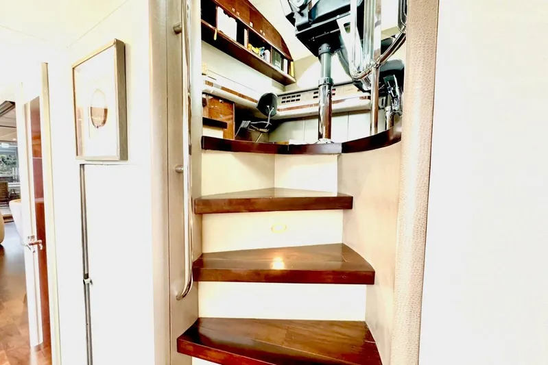 Serendipity Yacht Photos Pics Staircase inside 2001 Lazzara 94 Motor Yacht with wooden steps and metal railing.