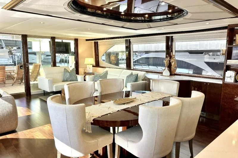 Serendipity Yacht Photos Pics Luxurious interior of 2001 Lazzara 94 Motor Yacht with elegant dining area and plush seating.
