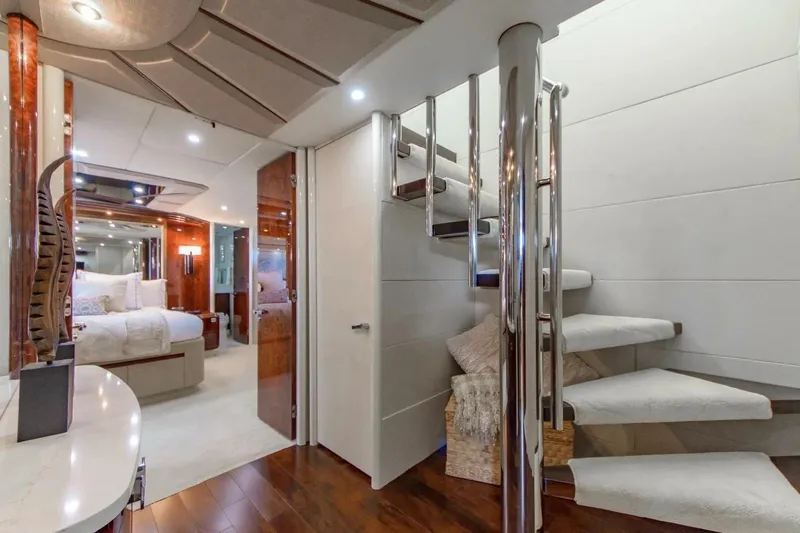 Serendipity Yacht Photos Pics Luxurious interior of 2001 Lazzara 94 Motor Yacht with elegant staircase and bedroom.