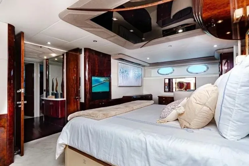 Serendipity Yacht Photos Pics Luxurious bedroom interior of 2001 Lazzara 94 Motor Yacht with elegant wood finishes.