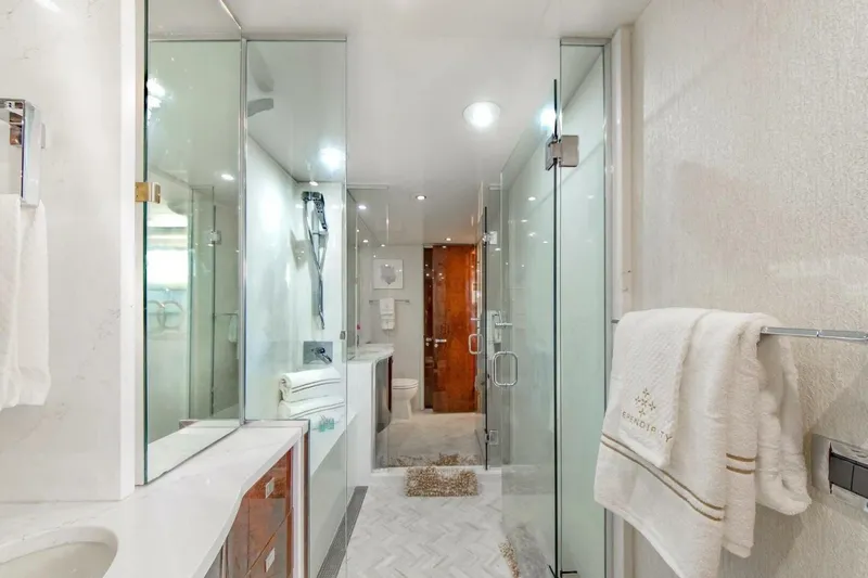 Serendipity Yacht Photos Pics Luxurious bathroom on 2001 Lazzara 94 Motor Yacht with glass shower and elegant decor.