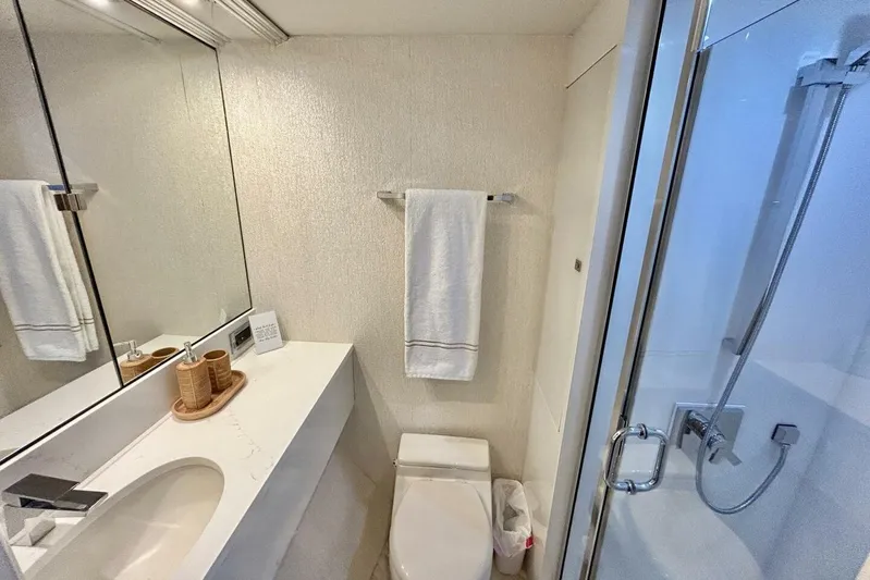 Serendipity Yacht Photos Pics Luxurious bathroom in 2001 Lazzara 94 Motor Yacht with modern fixtures and elegant design.