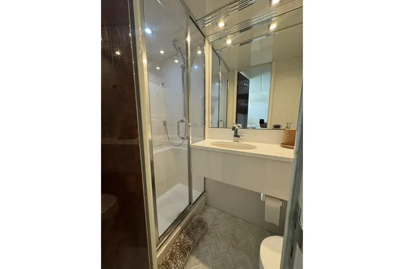 Serendipity Yacht Photos Pics Luxurious bathroom in 2001 Lazzara 94 Motor Yacht with modern fixtures and elegant design.