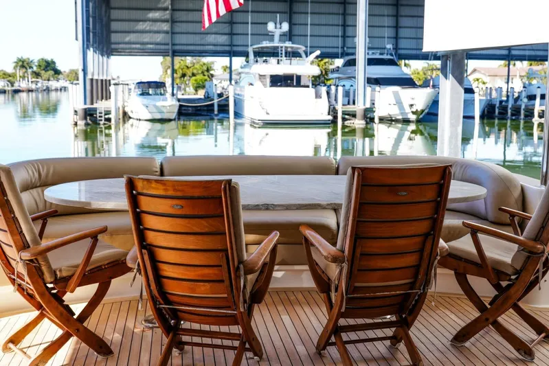 Serendipity Yacht Photos Pics Luxury Lazzara 94 Motor Yacht 2001, elegant outdoor seating with marina view.