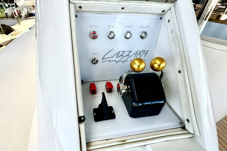 Serendipity Yacht Photos Pics Control panel of a 2001 Lazzara 94 Motor Yacht with throttle levers and switches.