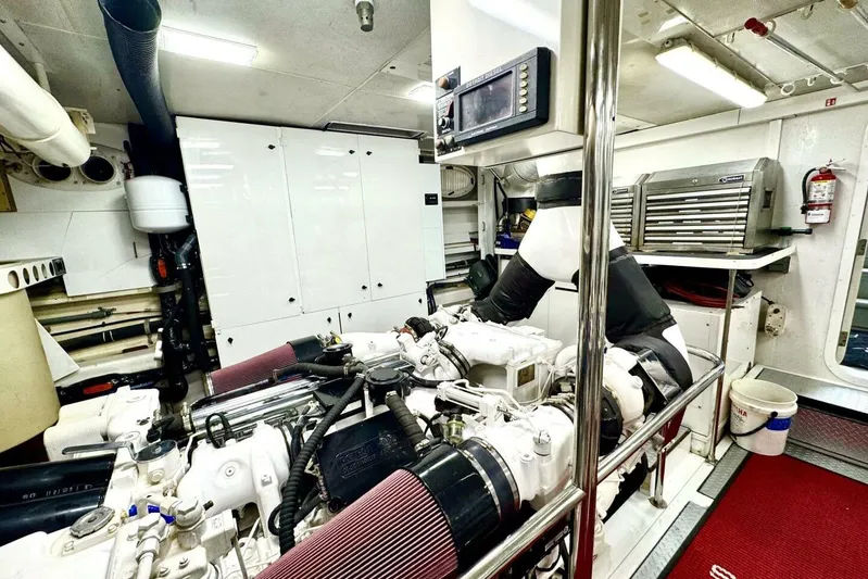 Serendipity Yacht Photos Pics Engine room of 2001 Lazzara 94 Motor Yacht, featuring machinery and storage cabinets.