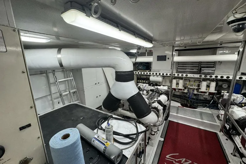 Serendipity Yacht Photos Pics Engine room of a 2001 Lazzara 94 Motor Yacht, featuring machinery and maintenance tools.