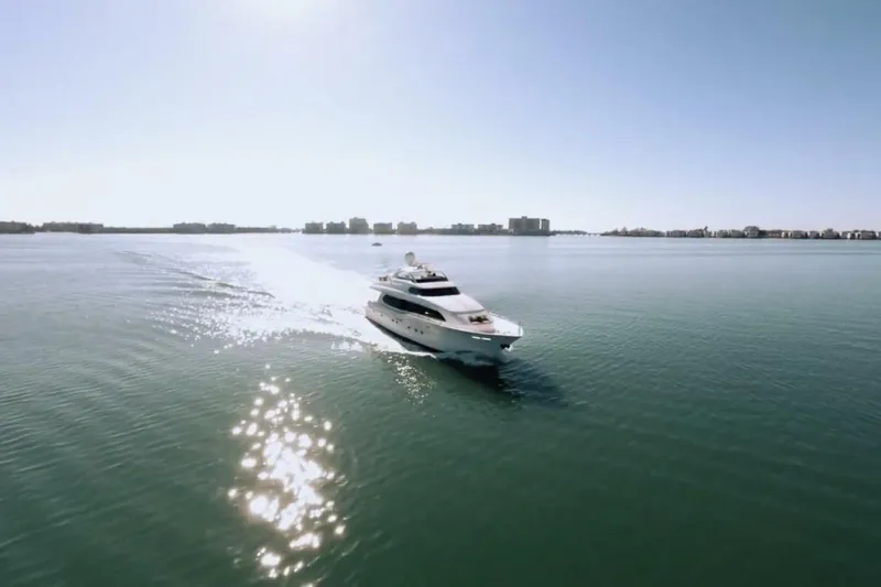 Serendipity Yacht Photos Pics Lazzara 94 Motor Yacht 2001 cruising on calm waters under clear sky.