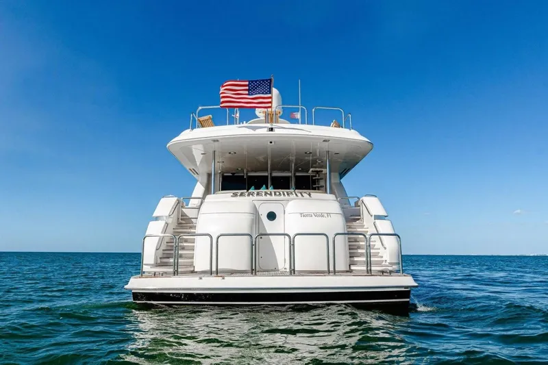Serendipity Yacht Photos Pics 2001 Lazzara 94 Motor Yacht on open water, American flag flying.