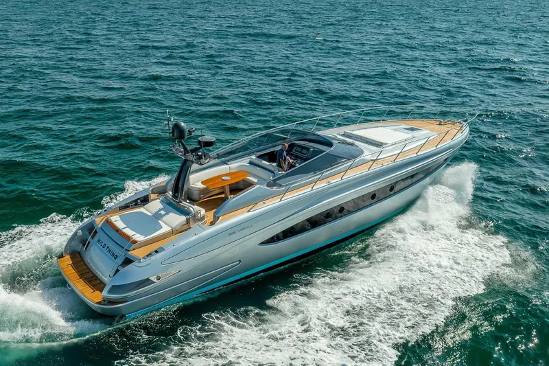 Mild Things Yacht Photos Pics 2014 Riva 63 Virtus yacht cruising on open sea, showcasing sleek design and luxury.