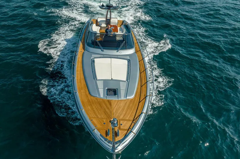 Mild Things Yacht Photos Pics 2014 Riva 63 Virtus yacht cruising on open sea, aerial view.