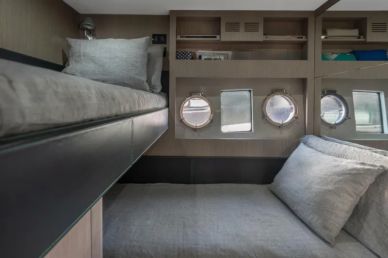 Mild Things Yacht Photos Pics Luxurious cabin interior of 2014 Riva 63 Virtus yacht with cozy bedding and porthole windows.