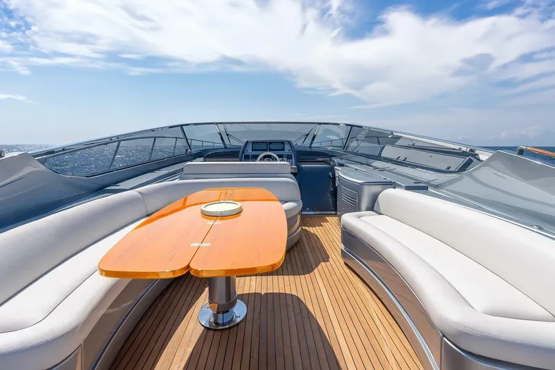 Mild Things Yacht Photos Pics Luxurious 2014 Riva 63 Virtus yacht with elegant seating and wooden deck under clear skies.