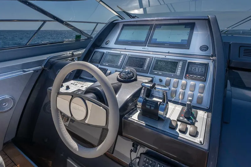 Mild Things Yacht Photos Pics 2014 Riva 63 Virtus yacht cockpit with advanced navigation controls and steering wheel.