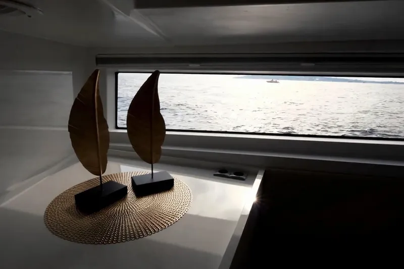  Yacht Photos Pics Interior view of 2019 DutchCraft DC56 yacht with decorative leaf sculptures and ocean view.
