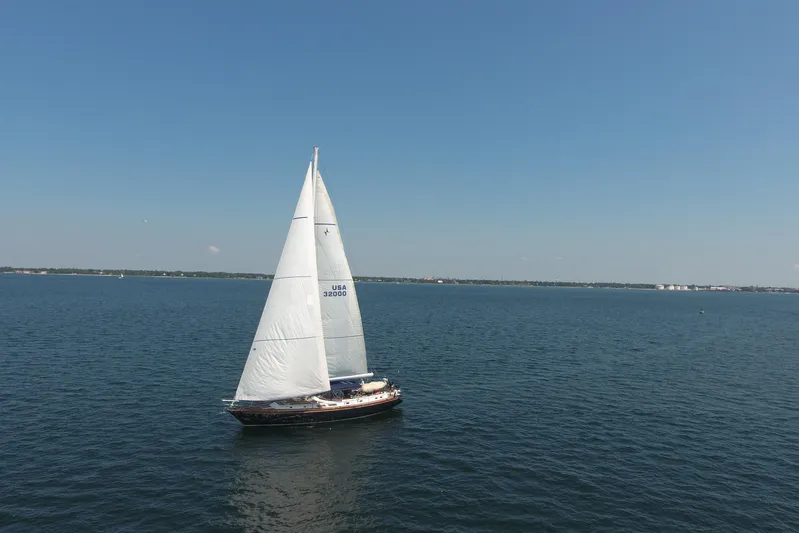 Independence Yacht Photos Pics Sailing yacht Gulfstar 60 CC (1981) on open water under clear blue sky.