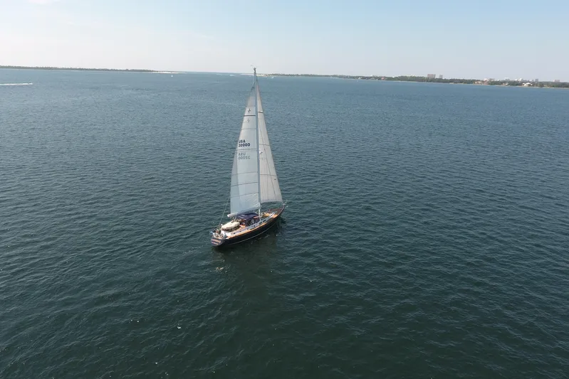 Independence Yacht Photos Pics Sailboat Gulfstar 60 CC from 1981 cruising on open water under clear skies.