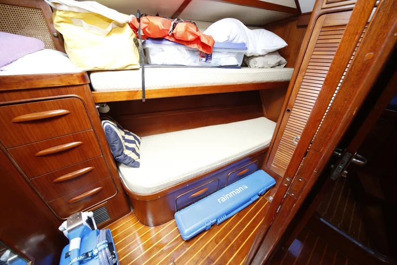 Independence Yacht Photos Pics Cozy cabin interior of 1981 Gulfstar 60 CC yacht with wooden furnishings and bunk beds.