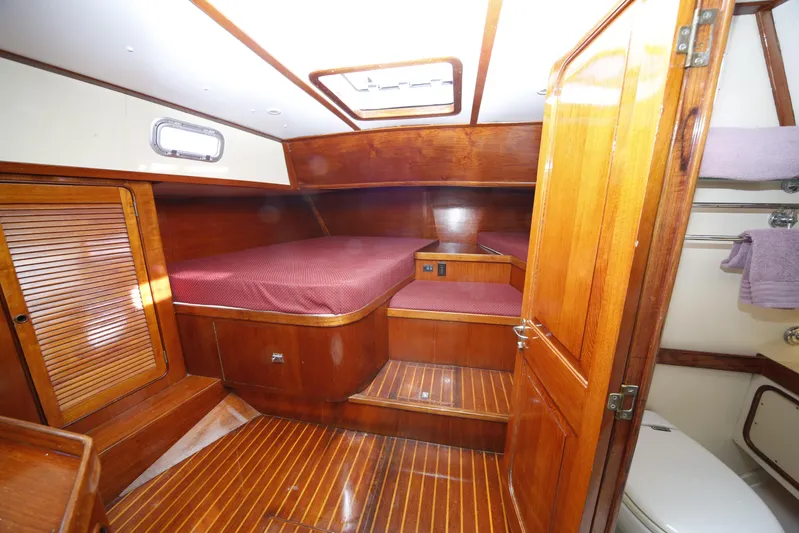 Independence Yacht Photos Pics 1981 Gulfstar 60 CC yacht cabin with wooden interior and cozy bed.