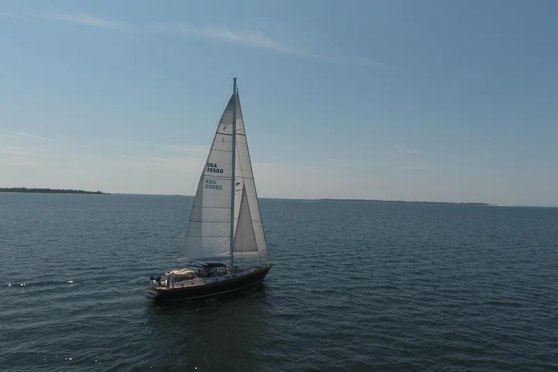 Independence Yacht Photos Pics Sailing yacht Gulfstar 60 CC from 1981 on open sea under clear blue sky.
