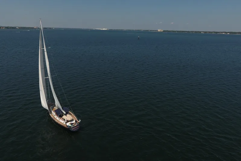Independence Yacht Photos Pics Sailing yacht Gulfstar 60 CC (1981) cruising on open water under clear skies.