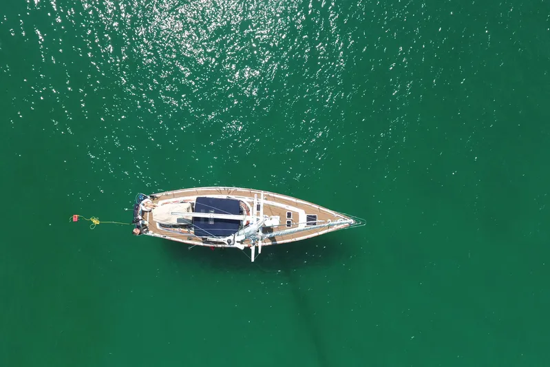 Independence Yacht Photos Pics Aerial view of 1981 Gulfstar 60 CC sailboat on calm green water.