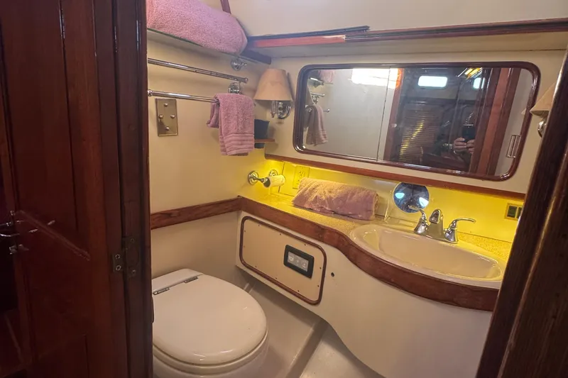 Independence Yacht Photos Pics 1981 Gulfstar 60 CC yacht bathroom with sink, mirror, and towel rack.