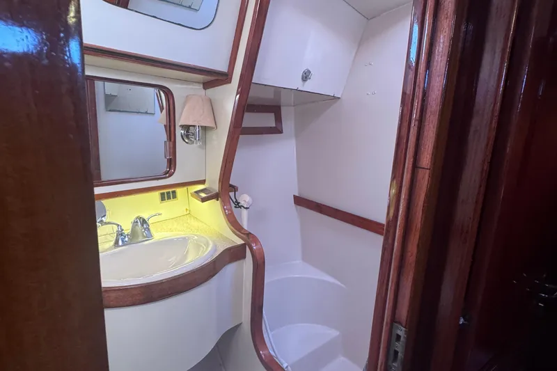 Independence Yacht Photos Pics 1981 Gulfstar 60 CC yacht bathroom with wooden accents and modern fixtures.