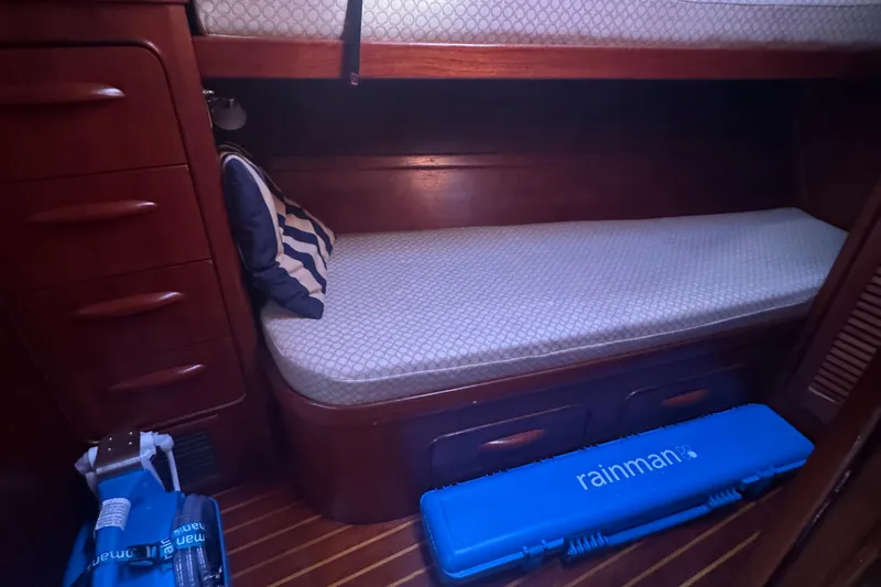 Independence Yacht Photos Pics Cozy cabin interior of 1981 Gulfstar 60 CC sailboat with wooden furnishings and bedding.