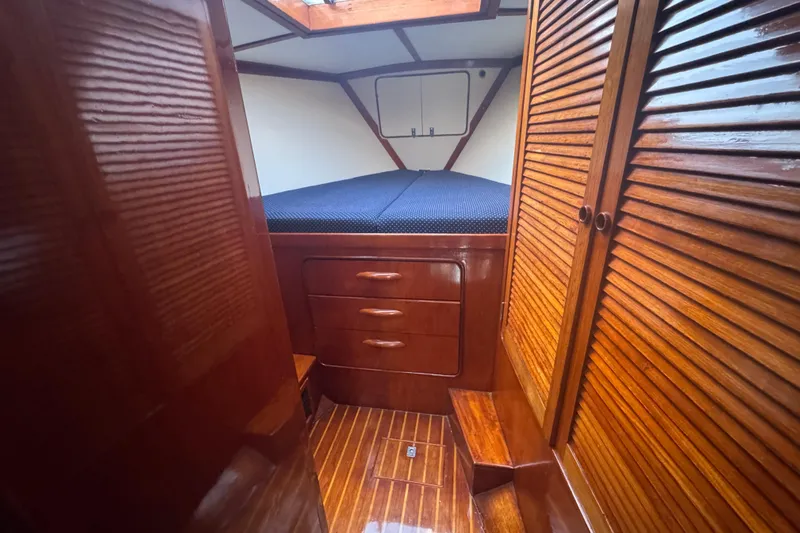 Independence Yacht Photos Pics 1981 Gulfstar 60 CC cabin interior with wooden finish and cozy bed.