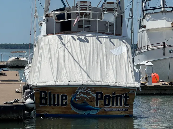 Blue Point Yacht Photos Pics 1998 Ocean Yachts 40 Super Sport docked, covered, with "Blue Point" signage.